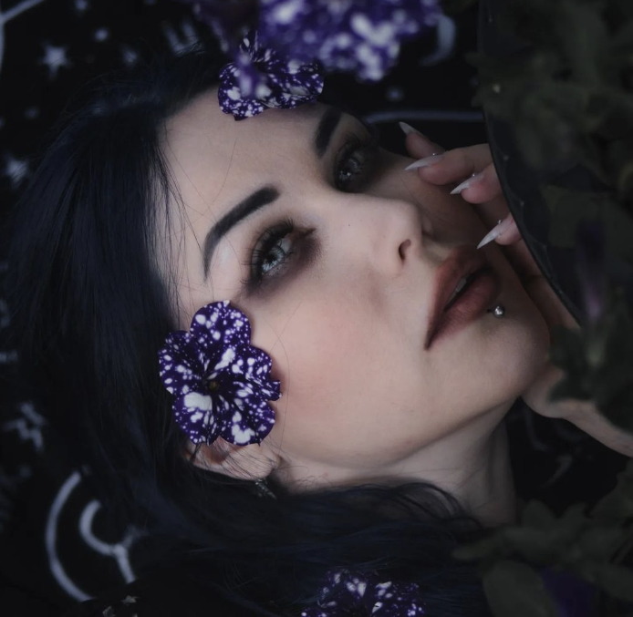 A blog author Blackthorn Witch of the Black Gothic Garden. Galaxy petunias on goth style hair.